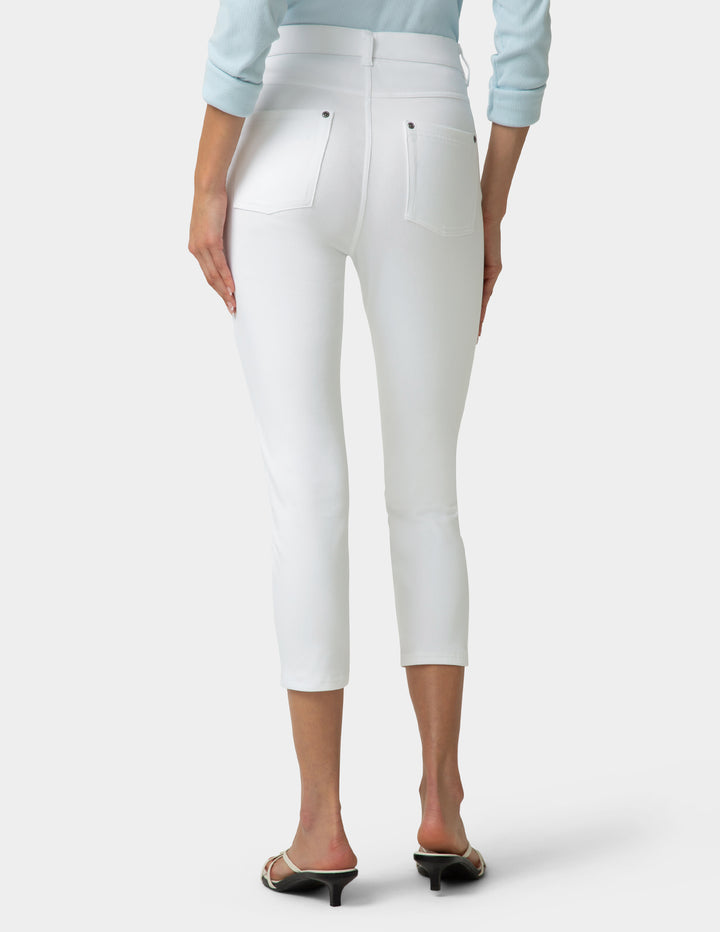 White pants worn by a person on a white background
