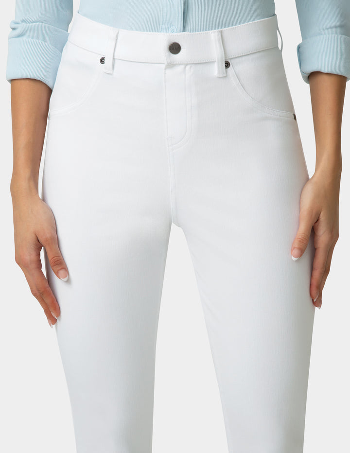 White pants worn by a person on a plain background