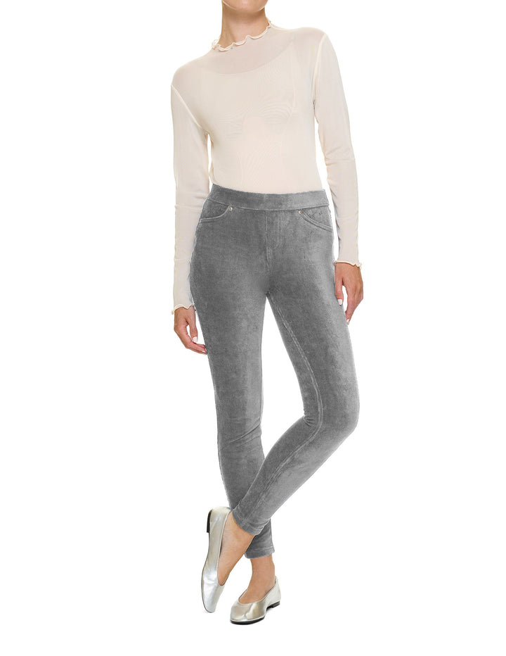 Person wearing a white long-sleeve top and gray pants on a white background