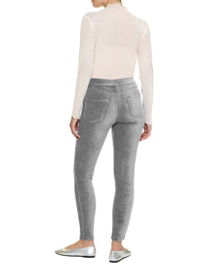 Person wearing gray pants and a white top on a white background