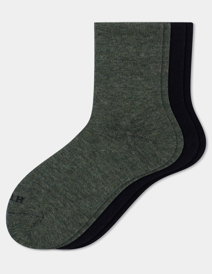 Two crew socks shown overlapping on a plain white background, with the front sock in heather olive and the back socks in solid black.