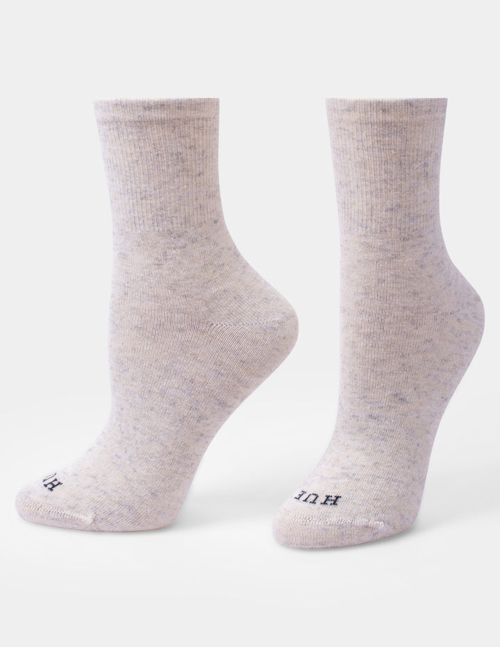 A pair of off-white crew socks shown from the side and back against a plain white background.