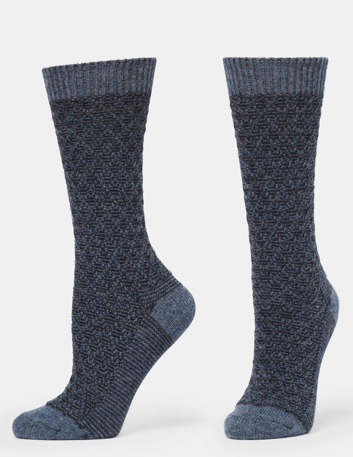 A pair of dark heathered blue crew socks with a textured knit pattern, shown from the side against a light gray background.