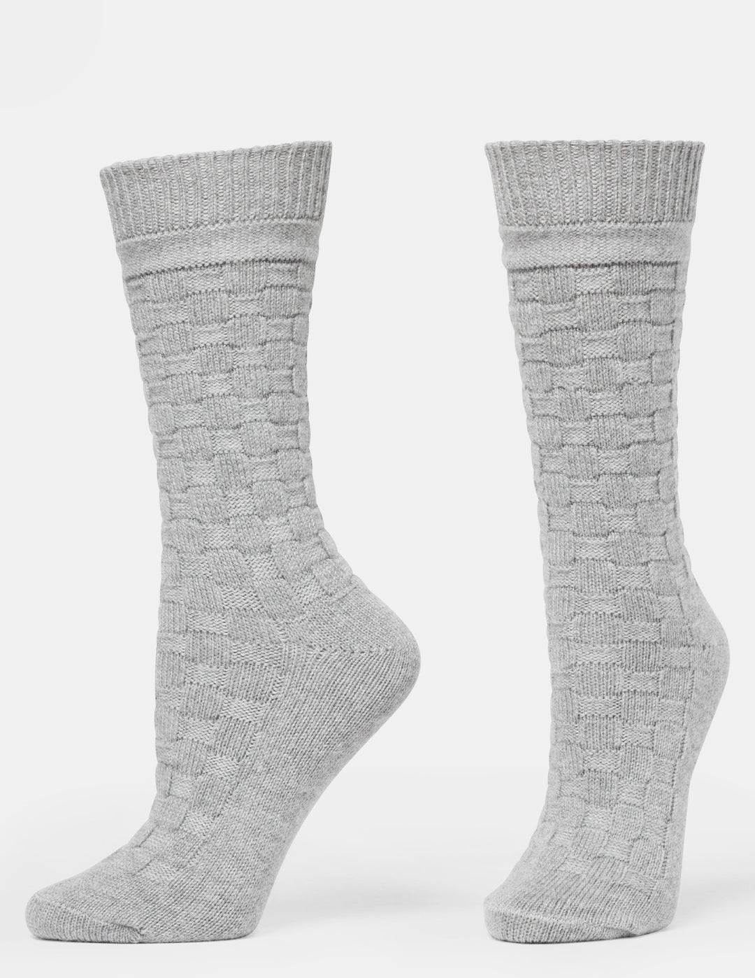 A pair of light gray crew socks with a textured basketweave knit pattern, displayed on invisible forms against a plain white background.