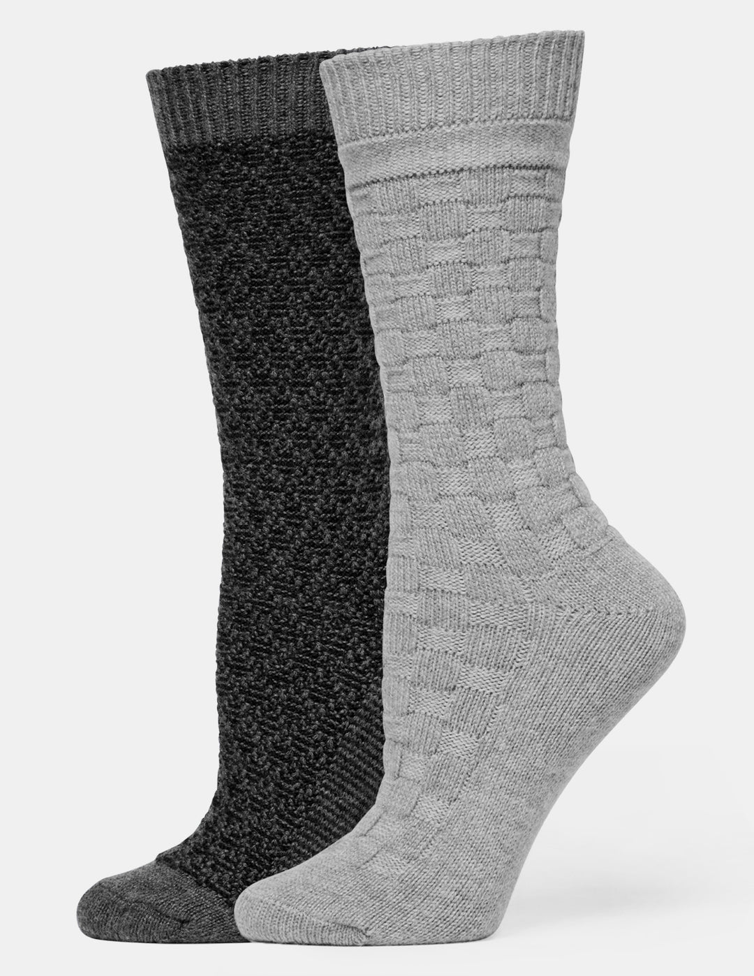 Two crew-length knit socks shown on invisible forms against a light gray background. The front sock is light gray with a textured cable-knit pattern, and the rear sock is black with a textured pattern.
