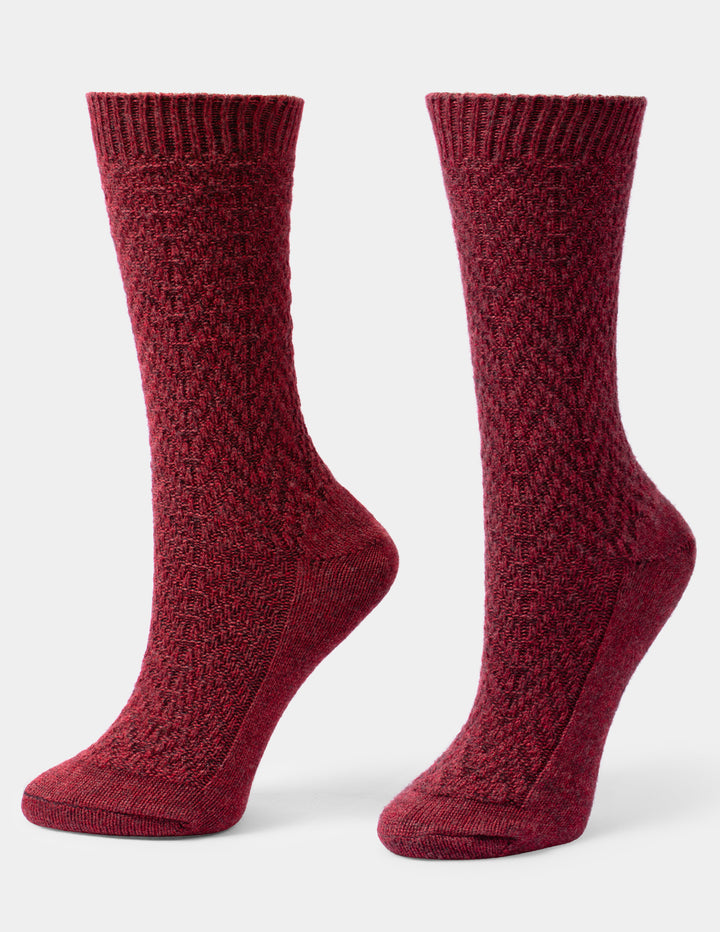 A pair of heathered burgundy crew socks with a textured knit pattern, shown on a light gray background.