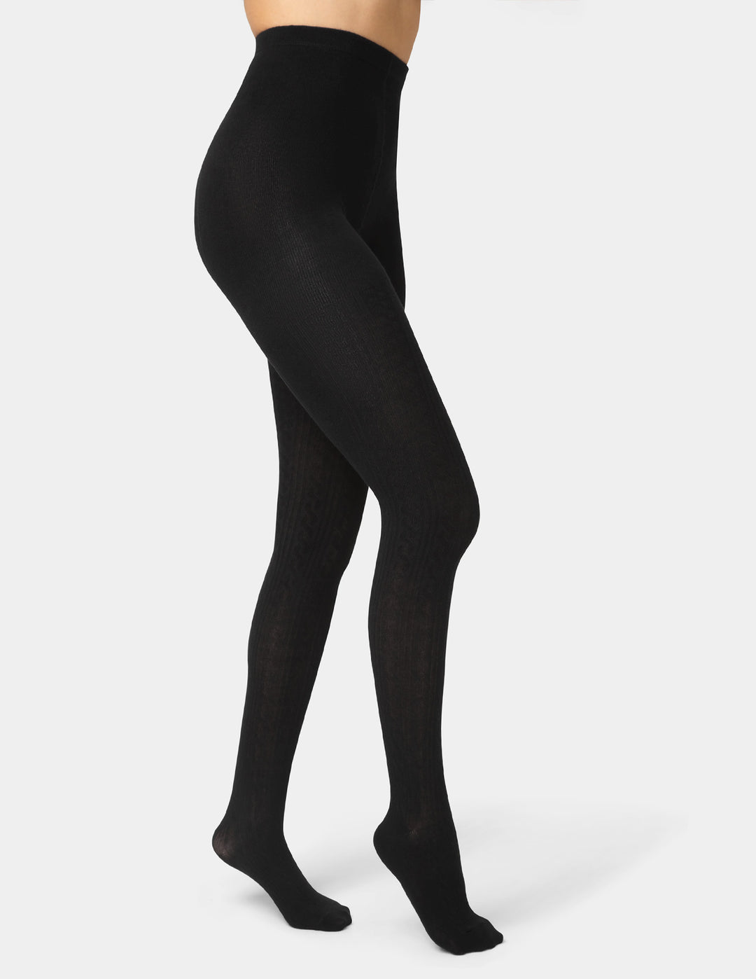 Black tights worn by a person on a white background