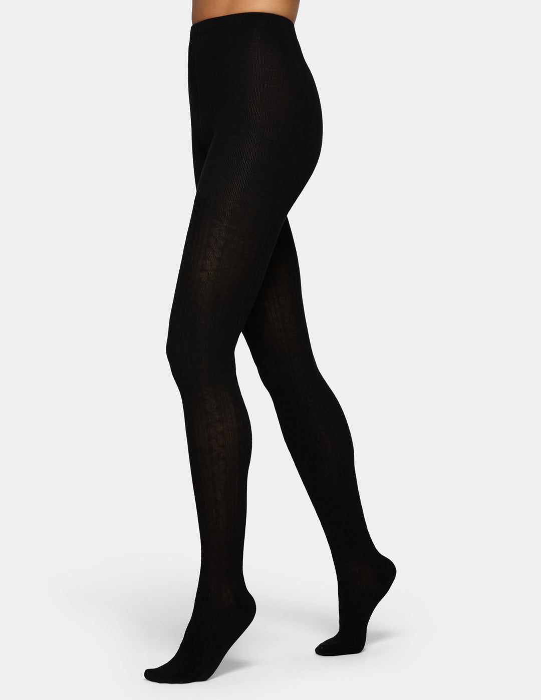 A model wearing black tights from the waist down