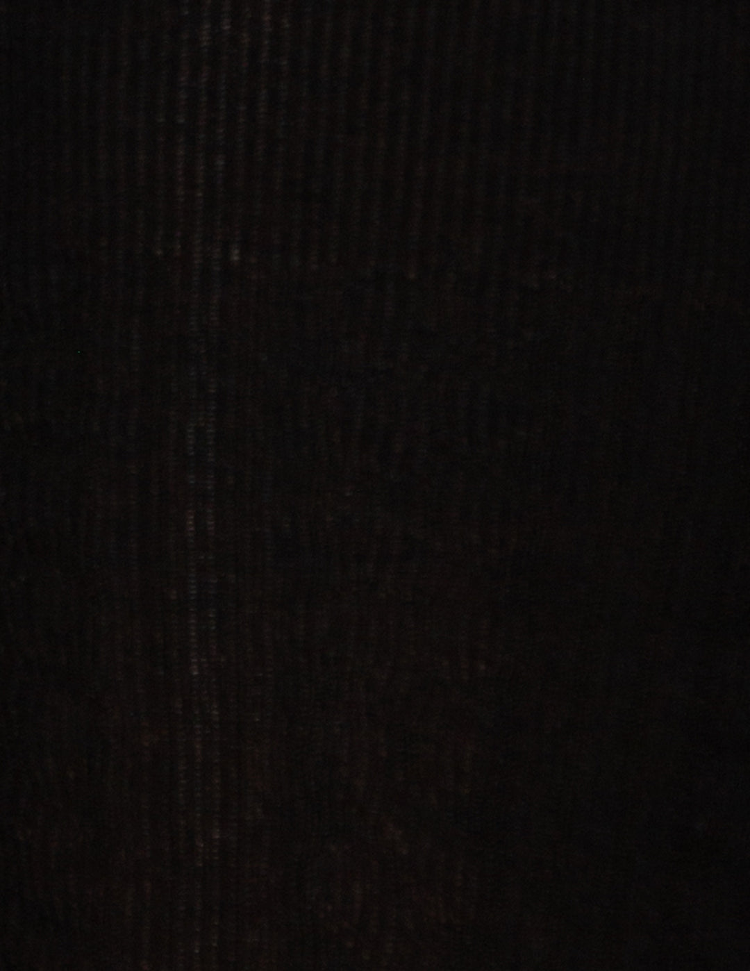 A close-up of a black ribbed knit fabric texture.