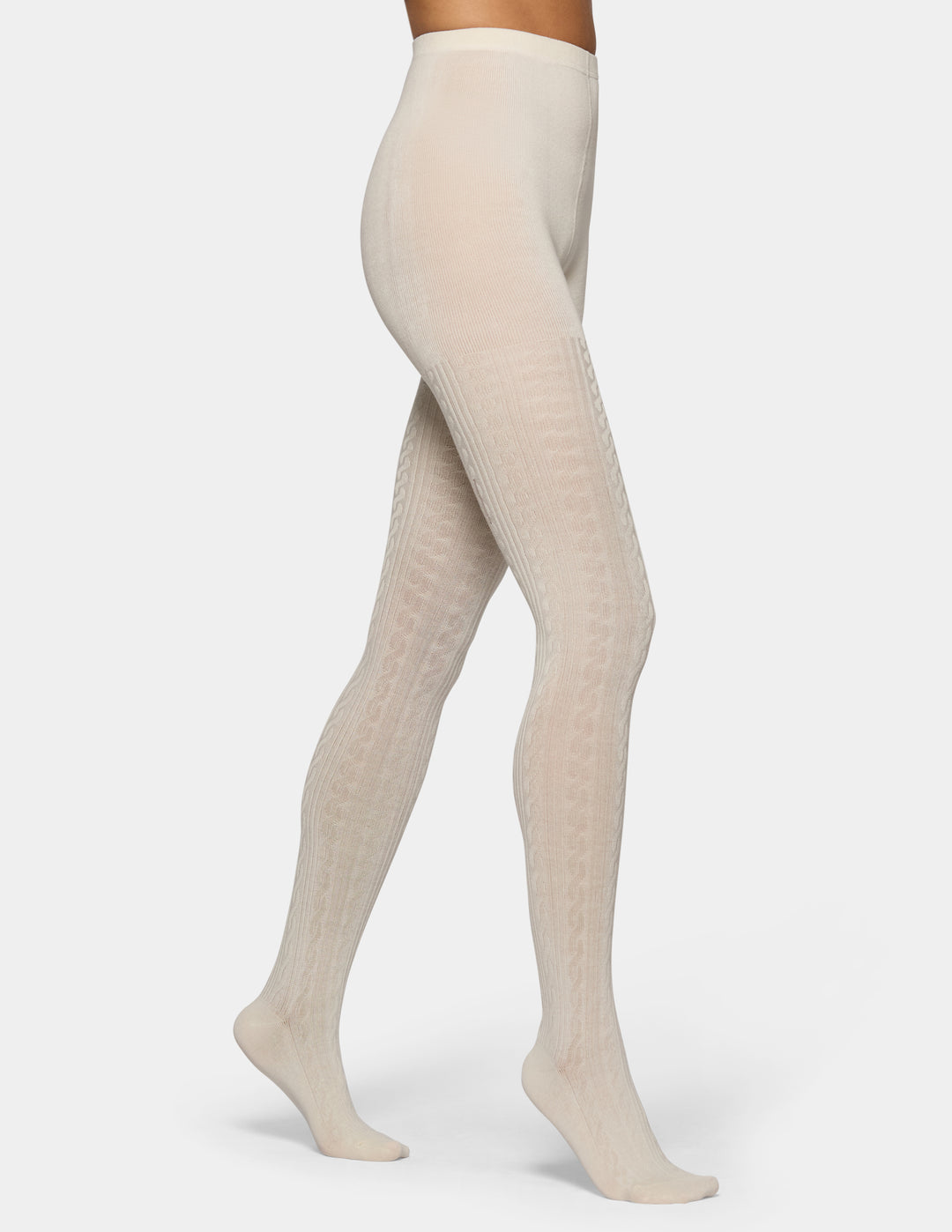 A model's legs wearing cream-colored, textured tights against a light gray studio background.