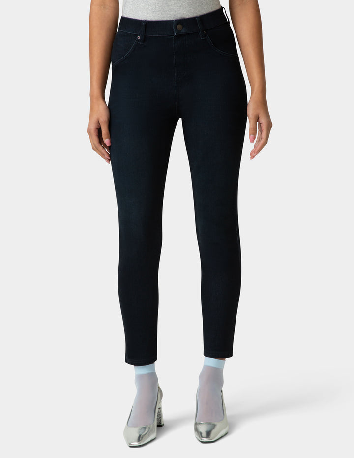 Person wearing black jeans on a white background