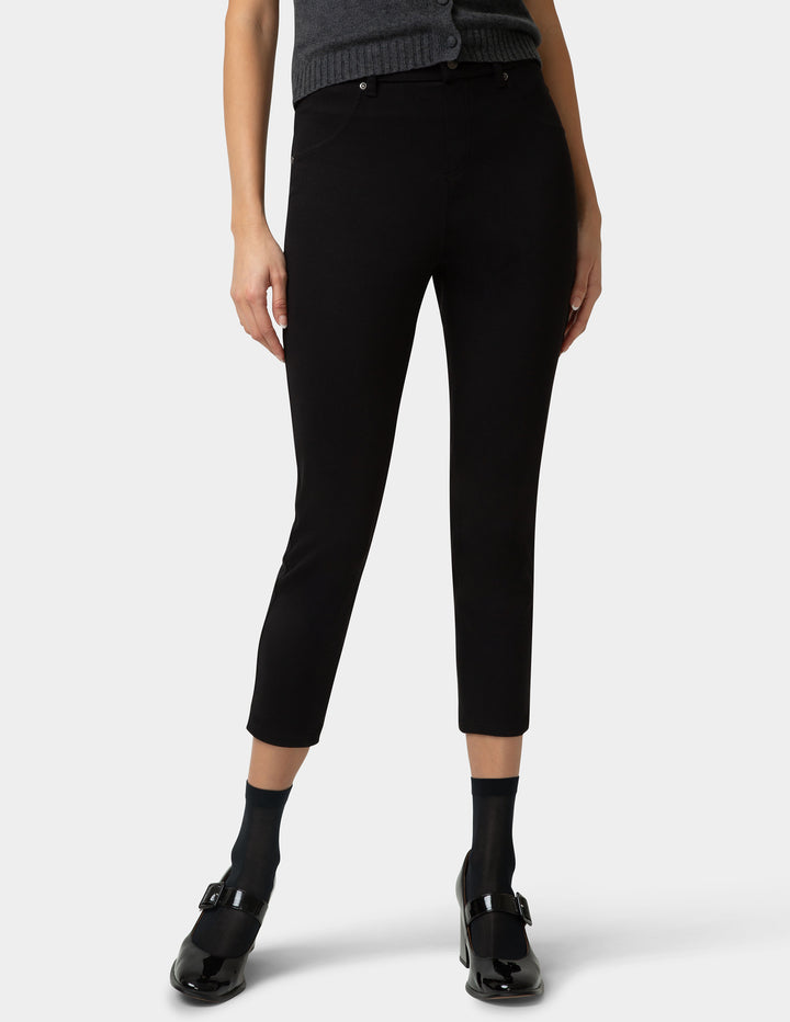 Person wearing black pants on a white background