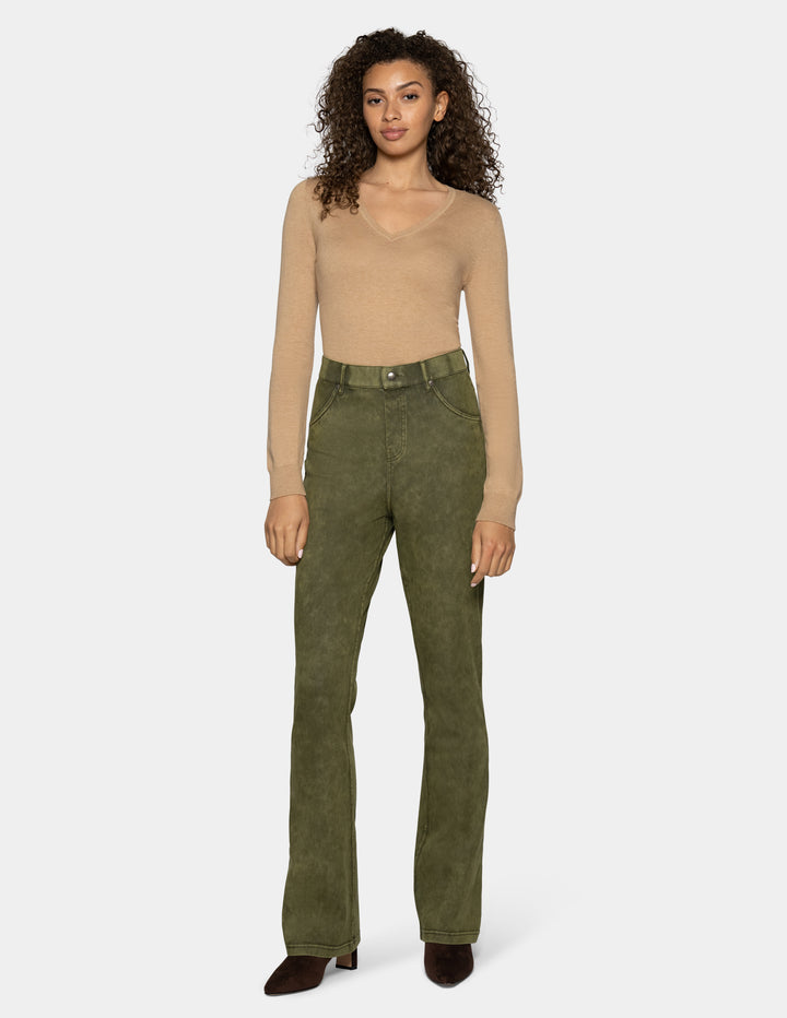 A model wearing olive green high-waisted bootcut pants, paired with a beige long-sleeve top and dark brown pointed-toe heels, against a light gray background.