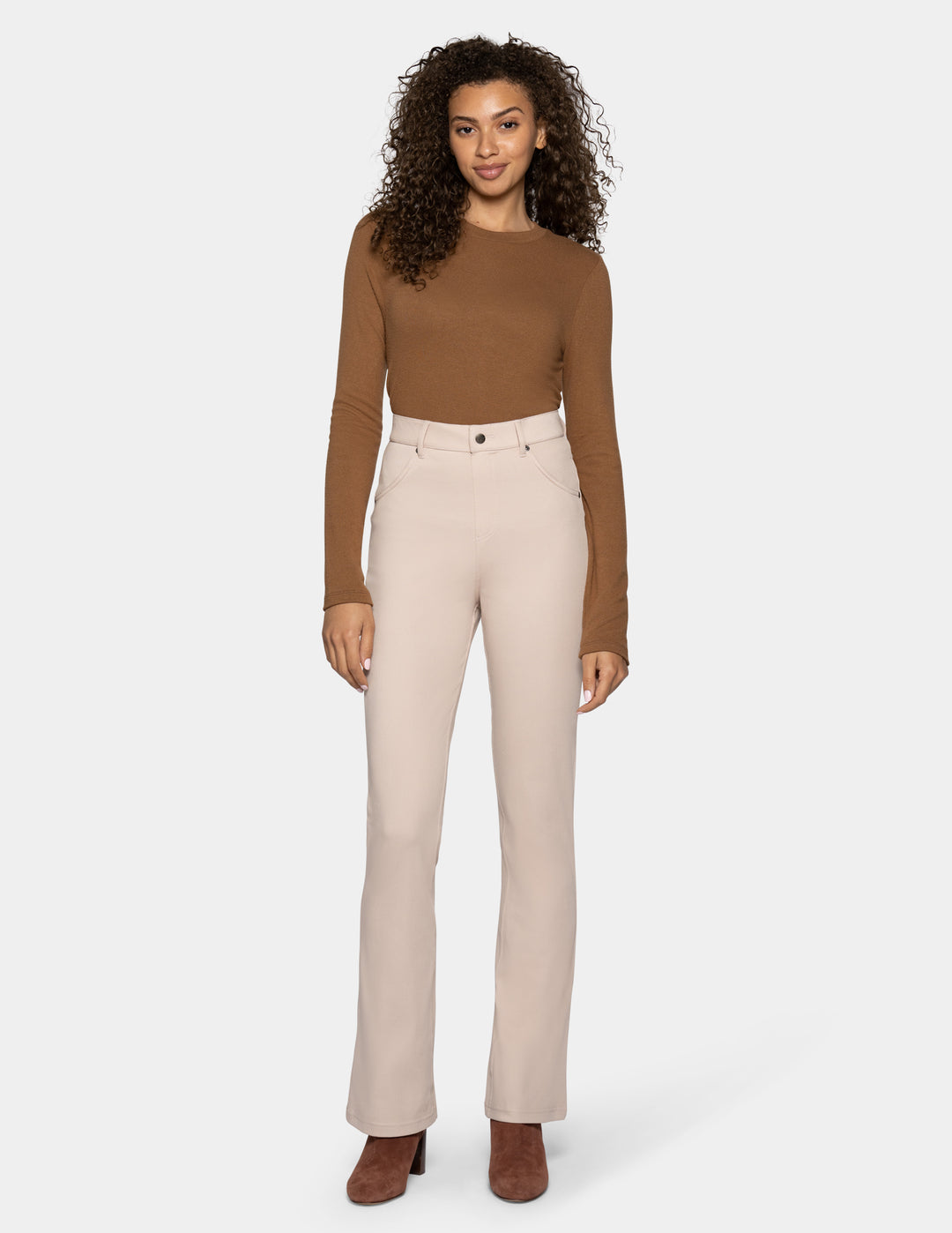 A woman modeling a brown long-sleeve knit top and light beige straight-leg trousers against a light gray background.