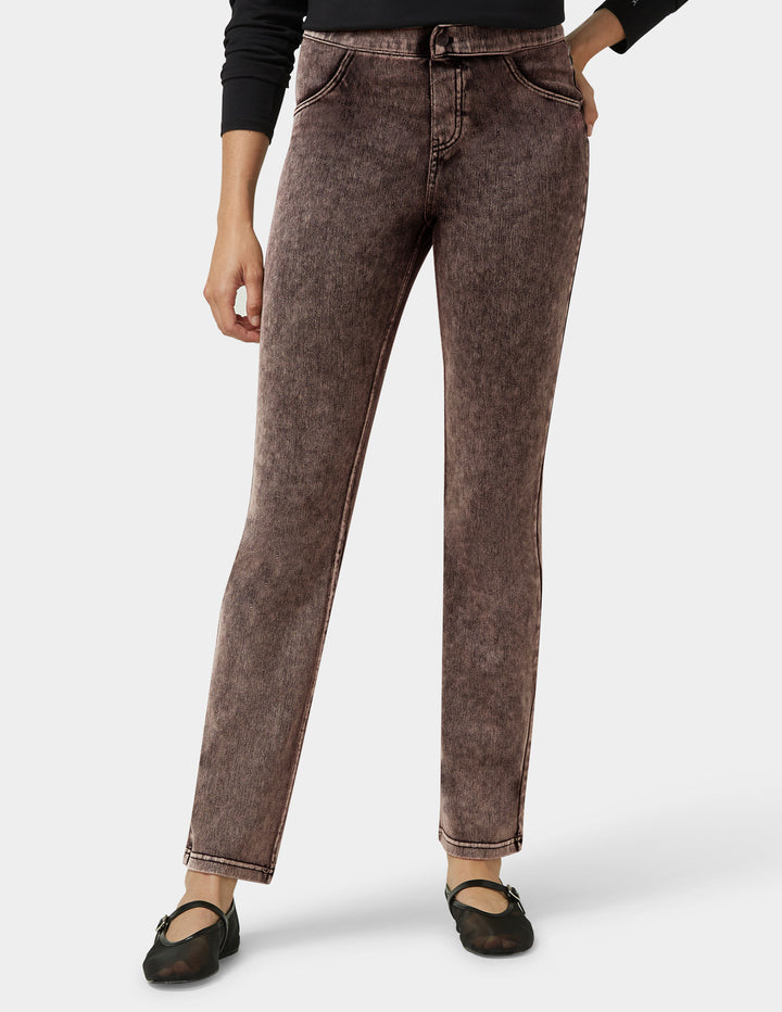 Brown jeans worn by a person on a white background