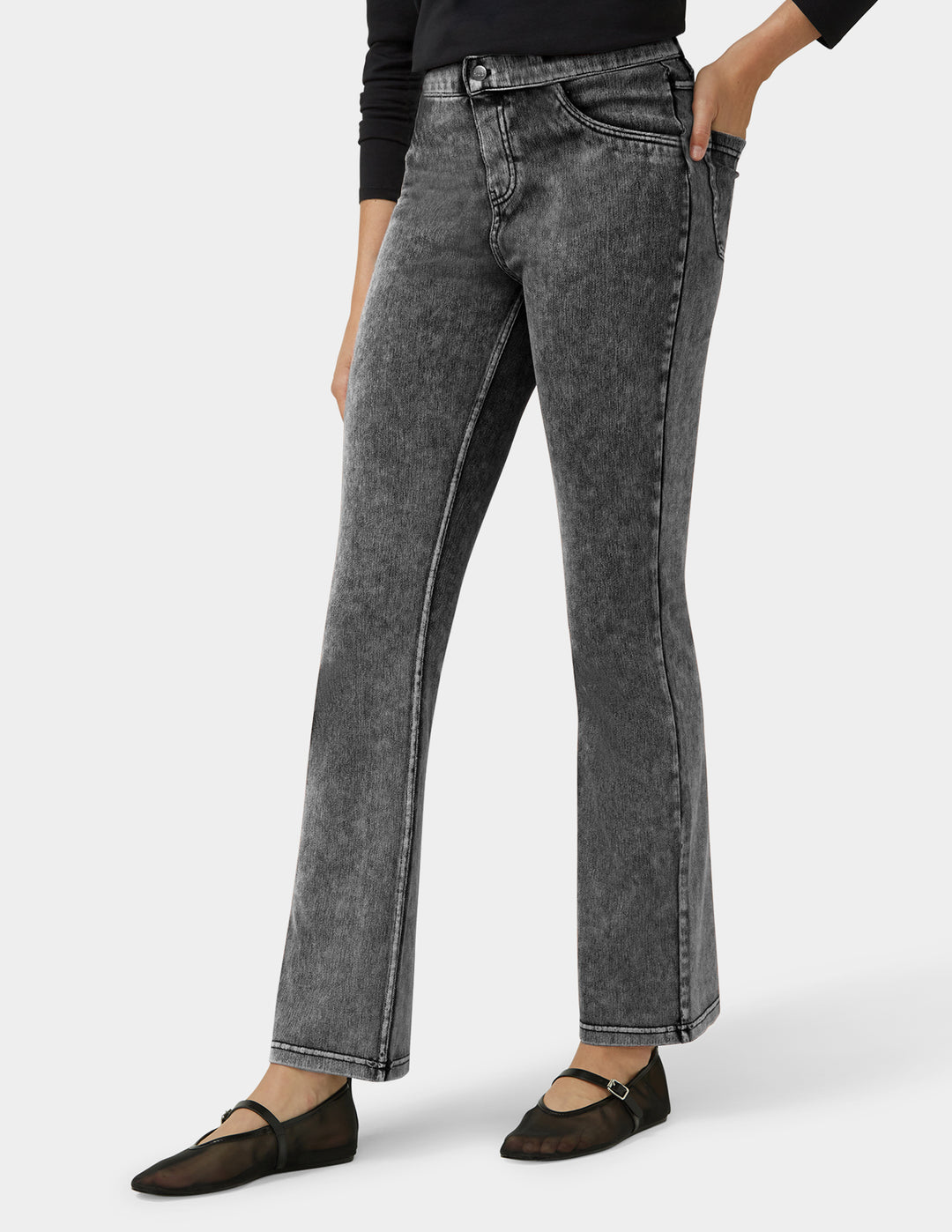 Person wearing gray straight-leg jeans on a white background