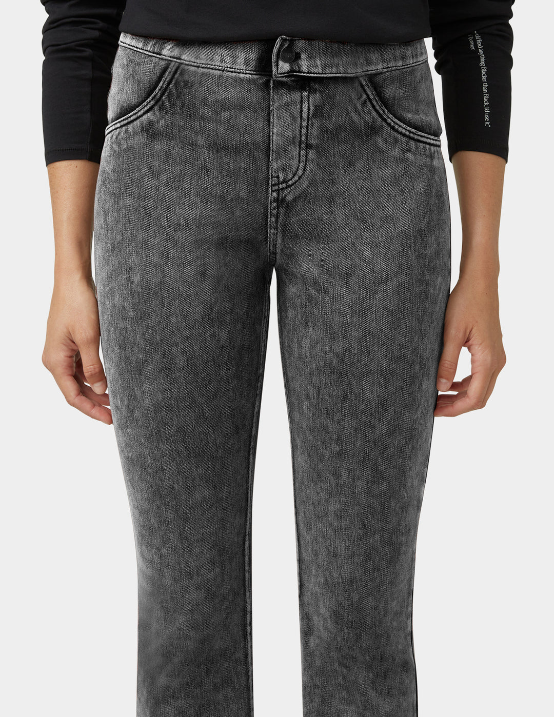 Person wearing gray jeans on a white background