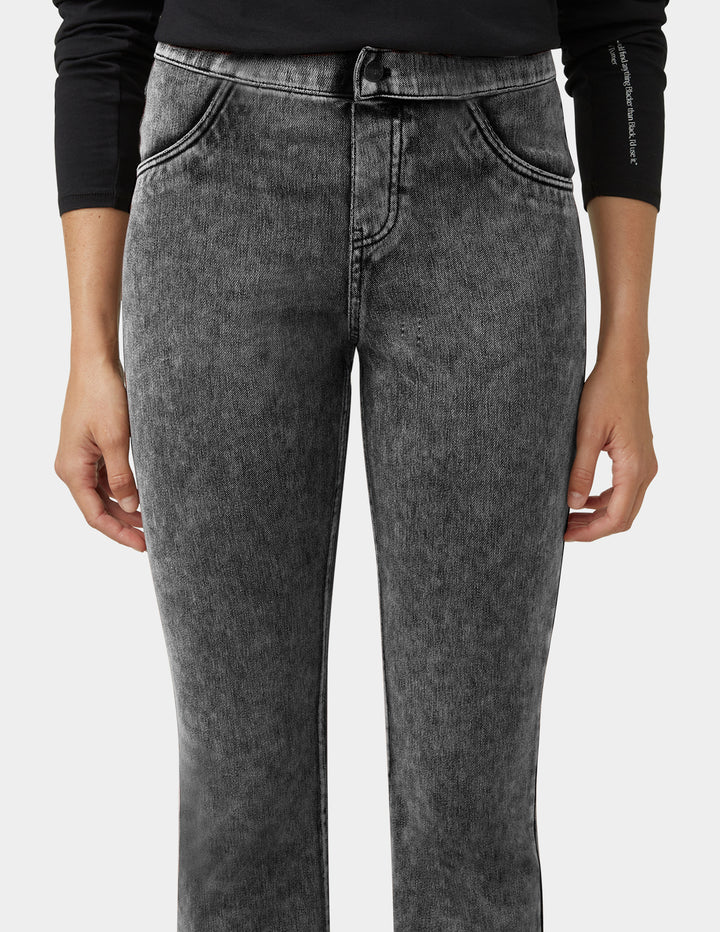 Person wearing gray jeans on a white background