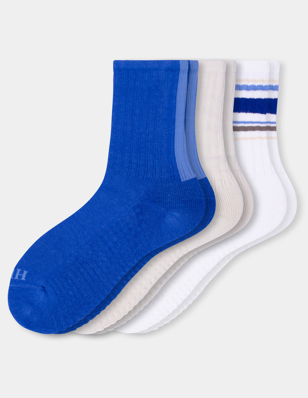A three-pack of crew socks in blue, white, and ivory, arranged in a fan shape against a light gray background.