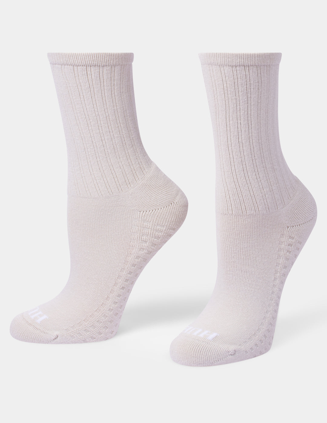 A pair of ribbed crew socks in an ivory color, displayed on a clean light gray background.