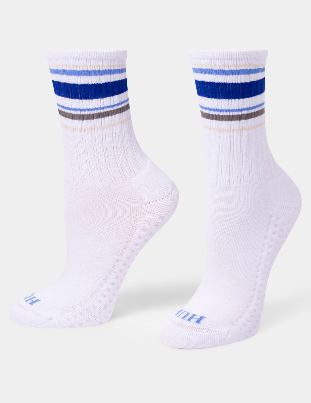 A pair of white crew socks with blue, gray, and light blue stripes near the cuff, displayed on a light gray background.