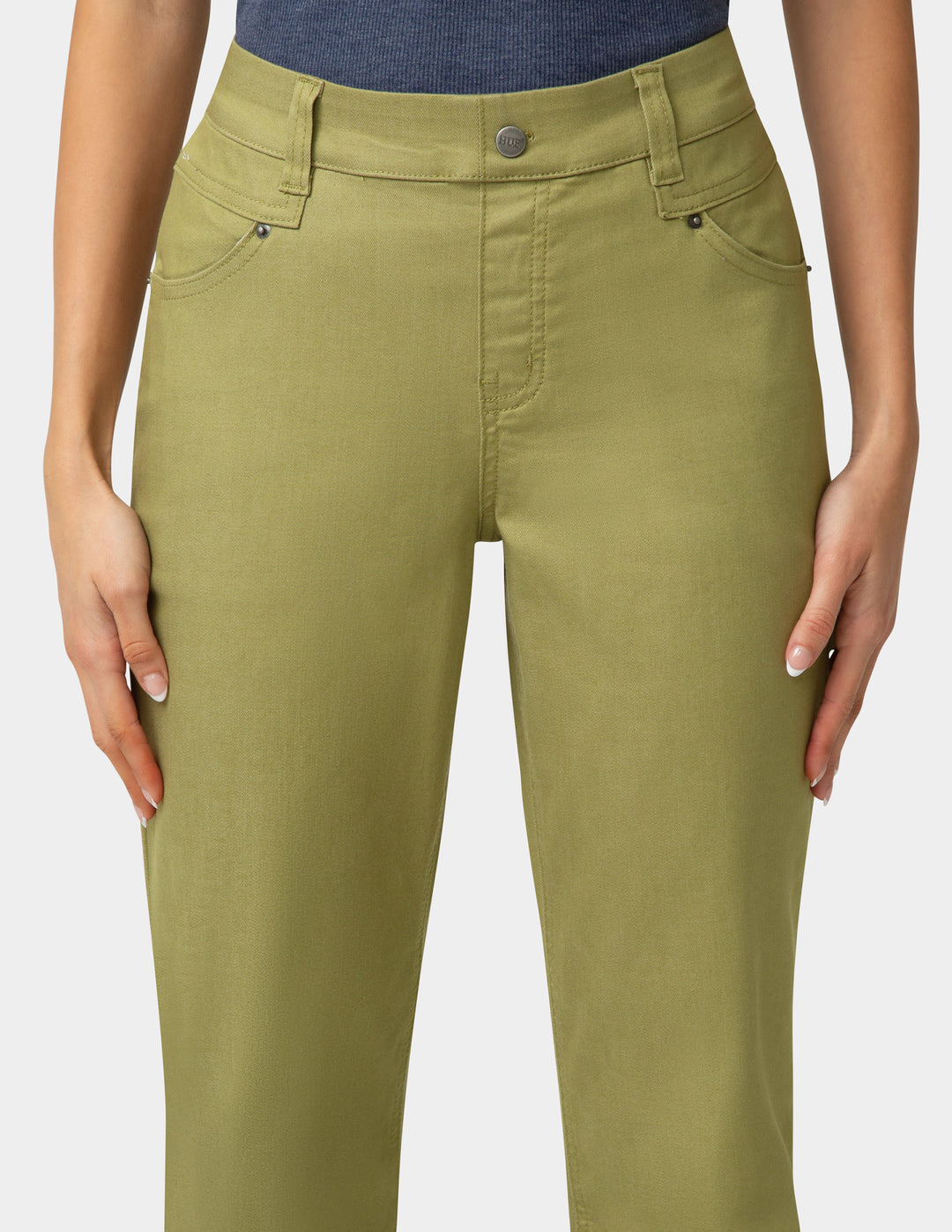 Green pants worn by a person on a white background