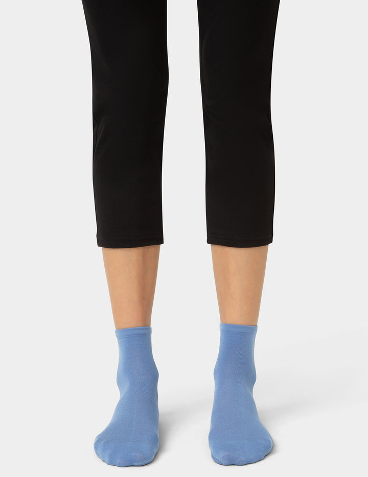 Person wearing blue pair of socks