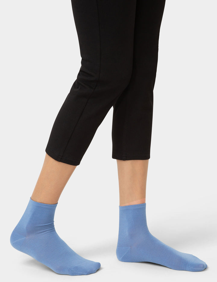 Person wearing blue pair of socks