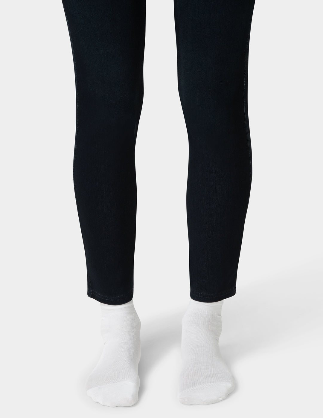 Black leggings worn by a person on a white background