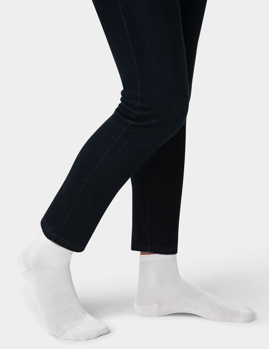 Black pants worn by a person on a white background