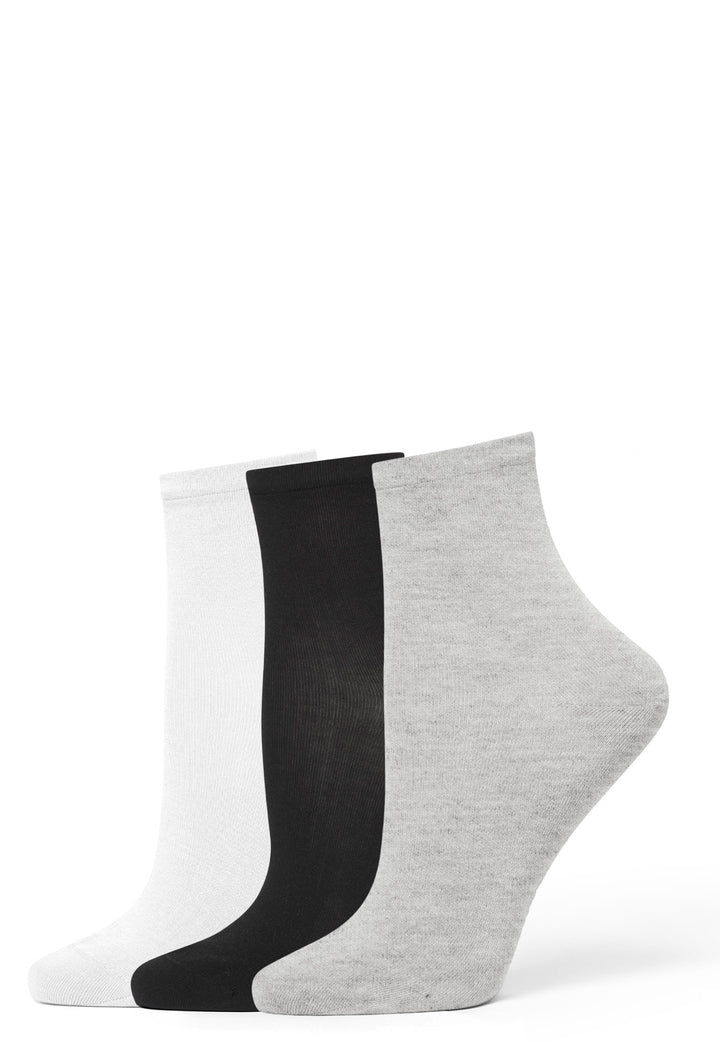Three pairs of socks in black, white, and gray on a white background
