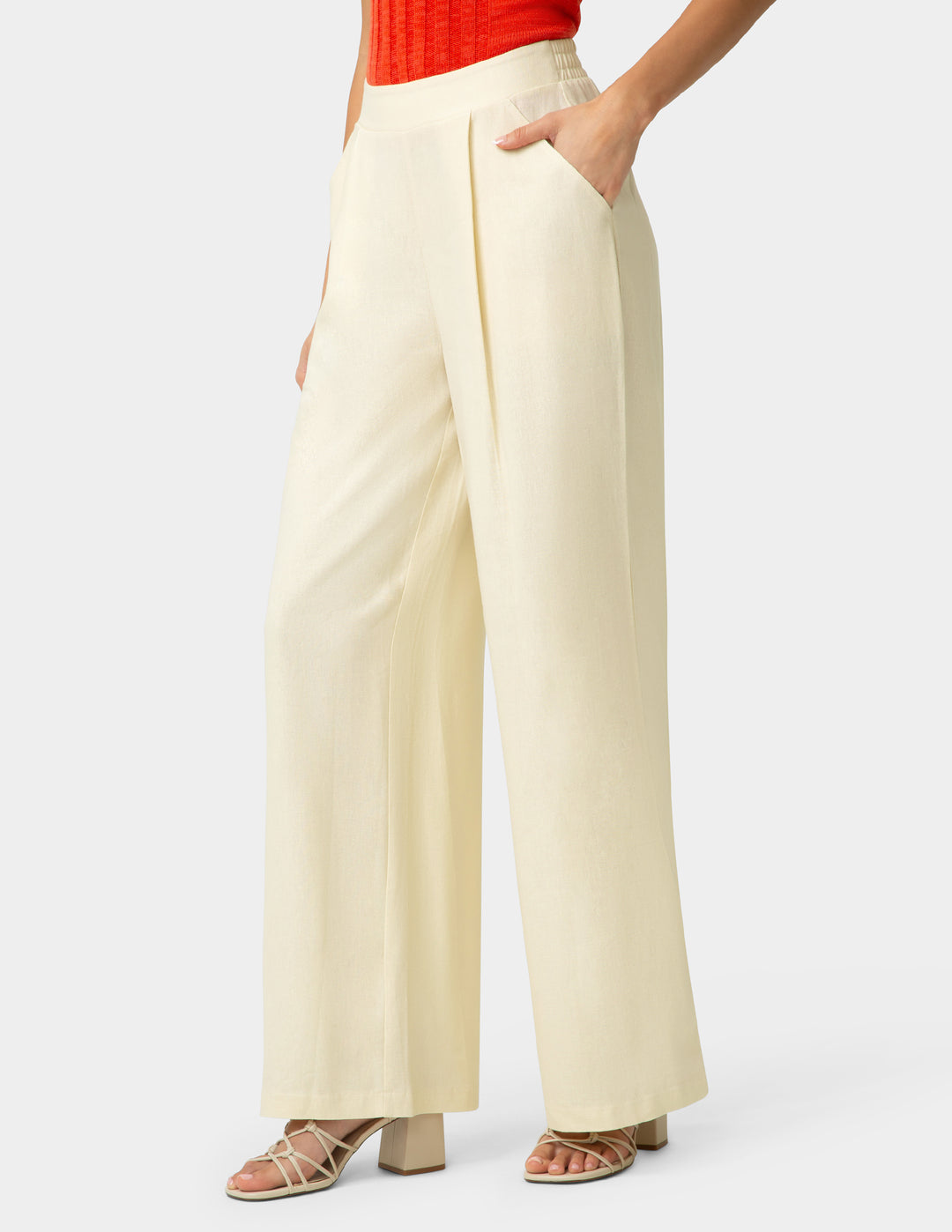Beige wide-leg pants worn by a person on a white background