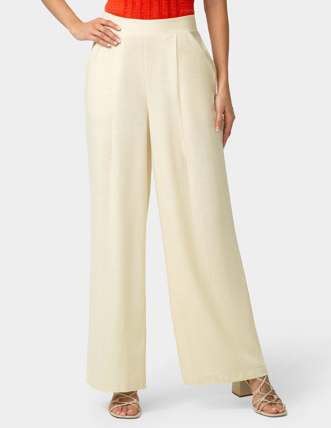 Beige wide-leg pants worn by a person on a white background