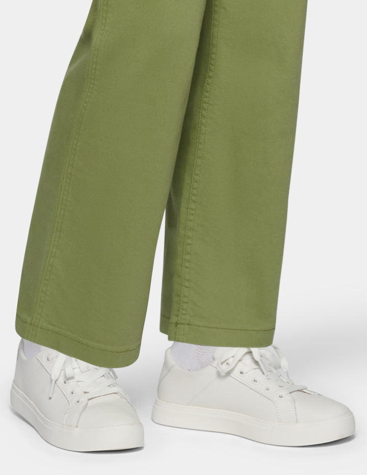Close-up of a person wearing olive green wide-leg pants 