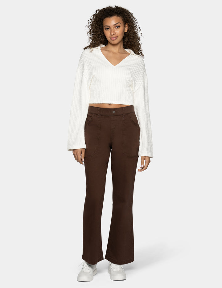 A model wearing dark brown wide-leg pants