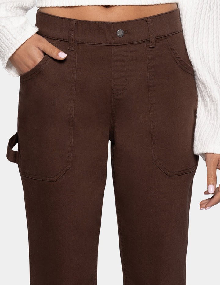 A close-up of a person wearing dark brown cargo-style pants 