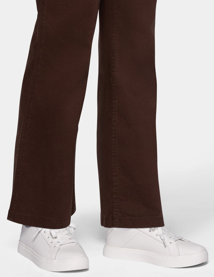 Close-up of a person wearing dark brown wide-leg pants