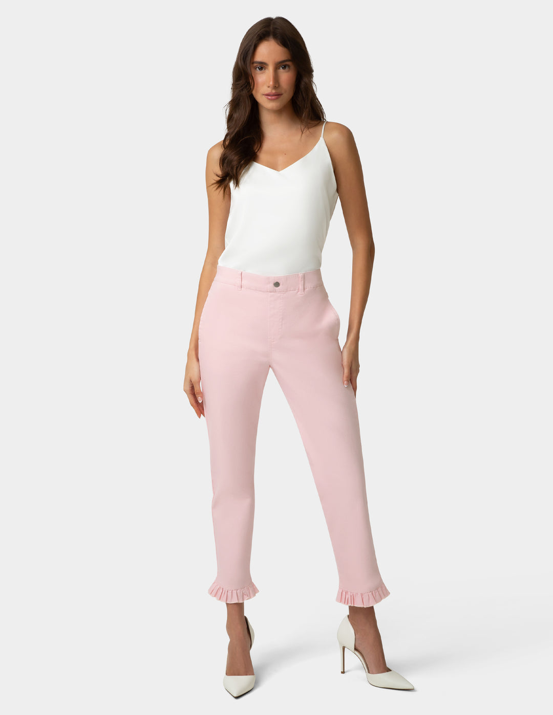Woman wearing a white top and pink pants on a white background