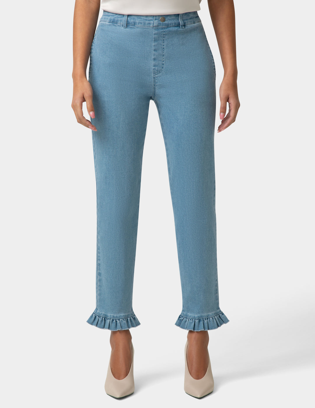 Light blue jeans with ruffled cuffs worn by a person on a white background