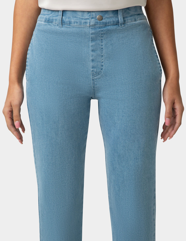 Light blue jeans worn by a person on a white background