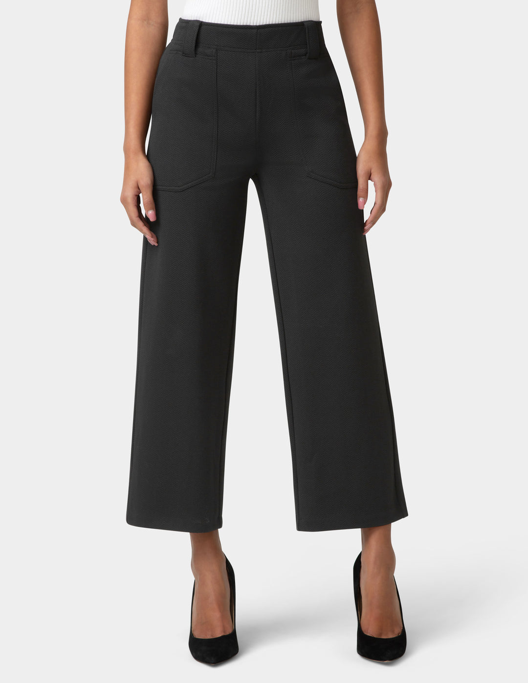 Black wide-leg pants worn by a person on a white background