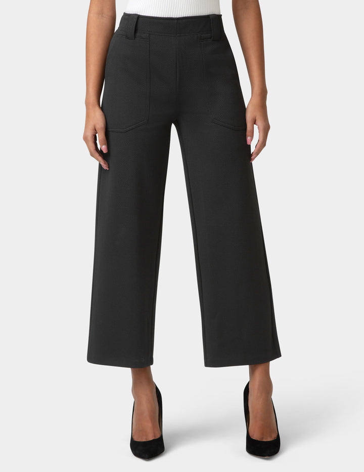 Black wide-leg pants worn by a person on a white background