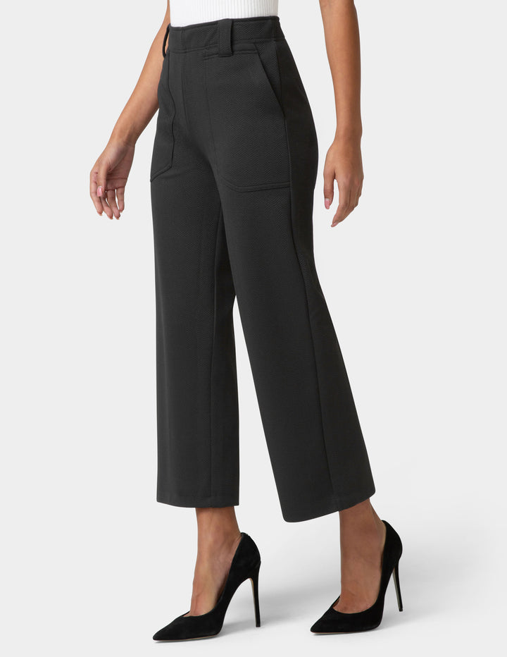 Black wide-leg pants worn by a person on a white background