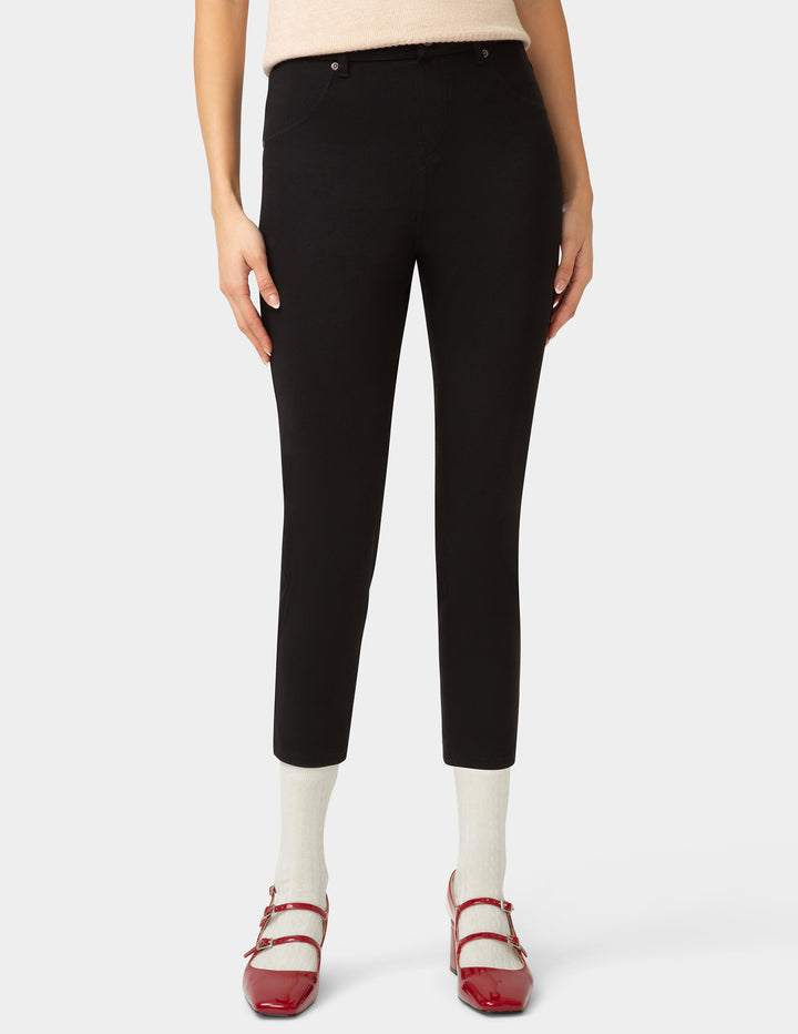 Person wearing black pants on a white background