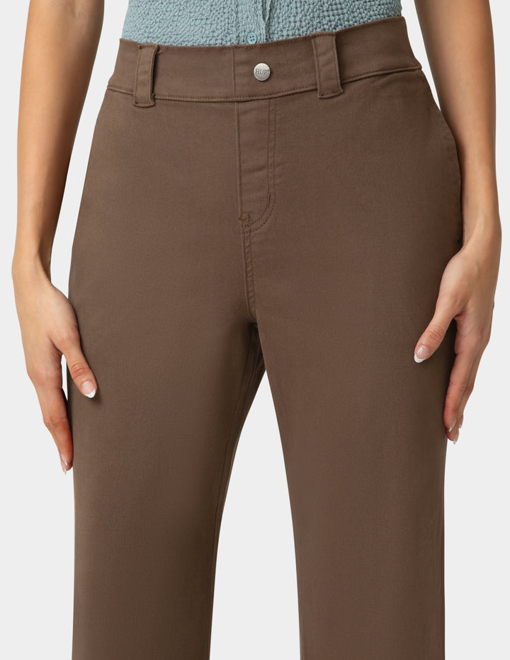 Brown pants worn by a person on a plain background