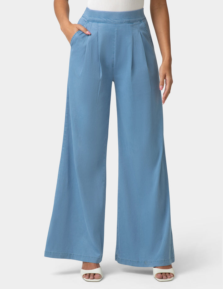 Blue wide-leg pants worn by a person on a white background