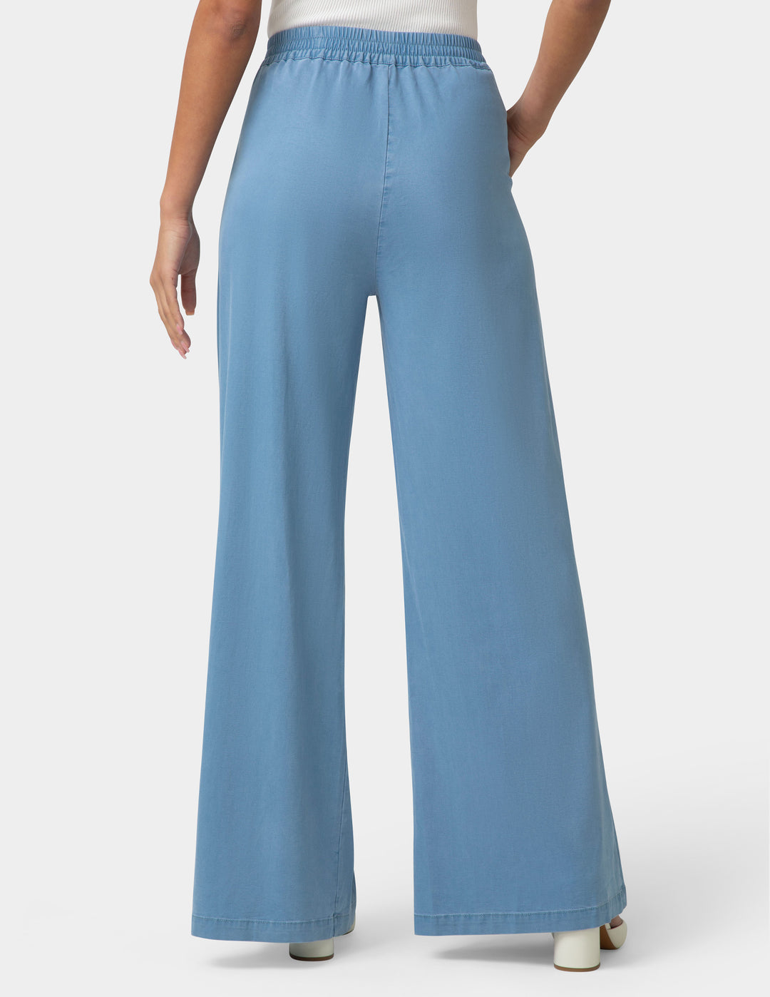Blue wide-leg pants worn by a person on a white background