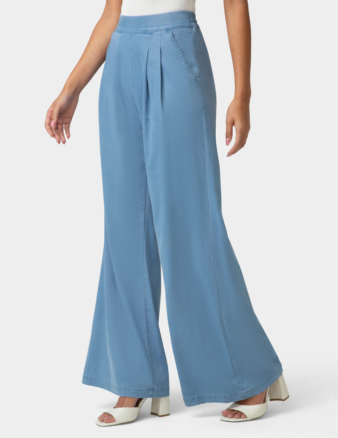 Blue wide-leg pants worn by a person on a white background