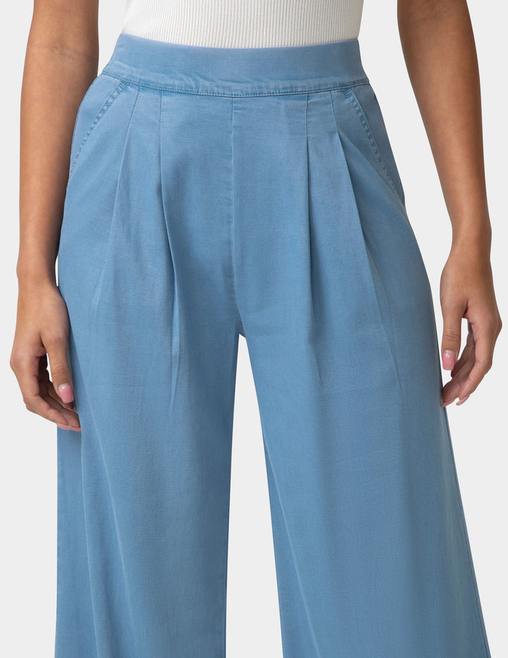 Light blue pants worn by a person on a white background