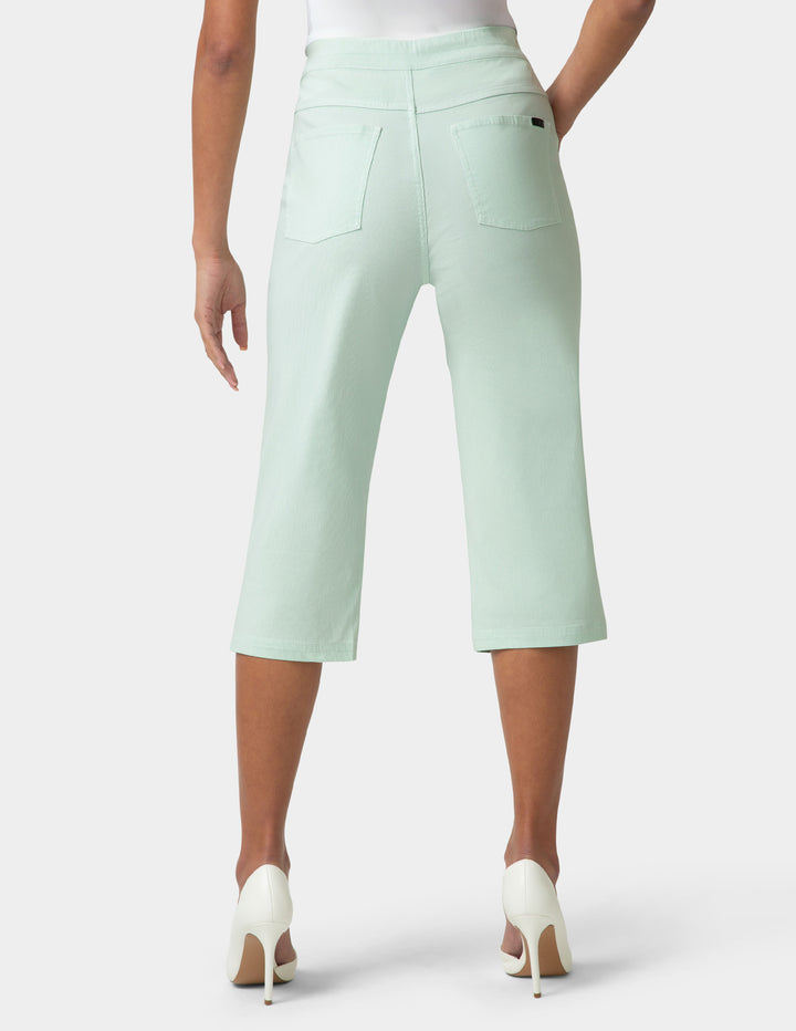 Light green capri pants worn by a person on a white background